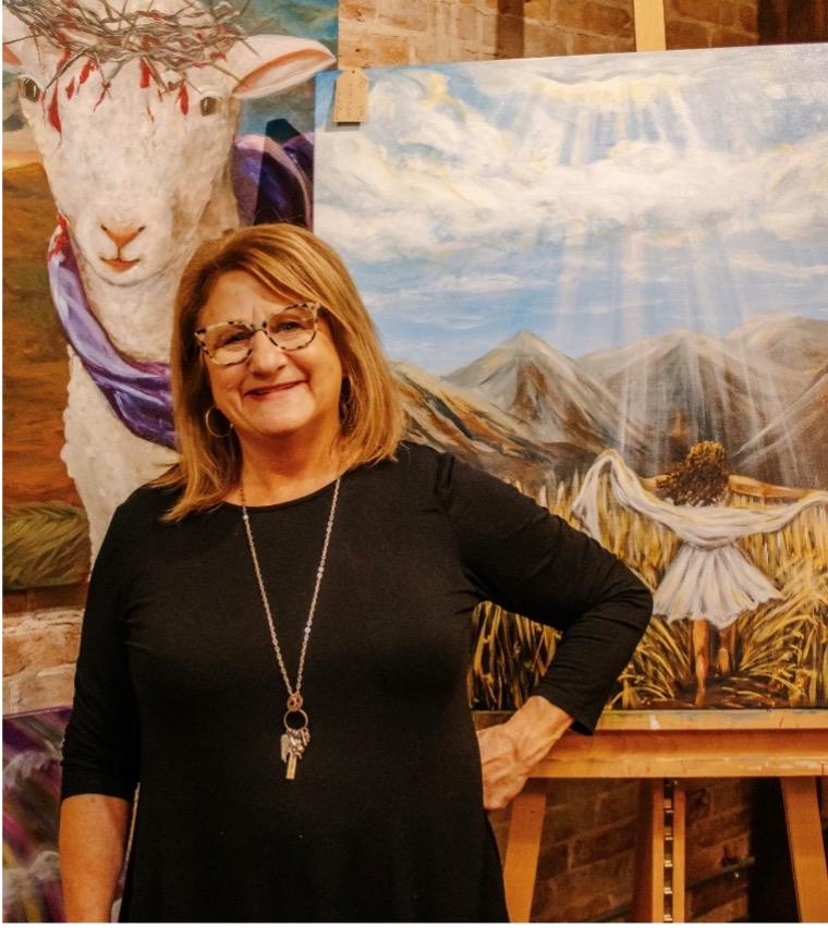 Artist Tammy Brown posing with her work